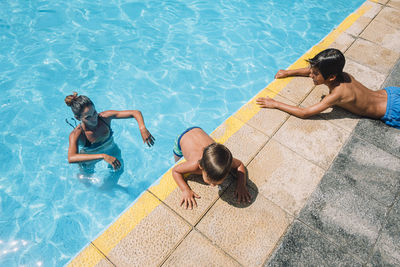 Family playing in a pool