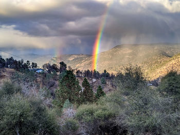 Rainbow over landscape against sky