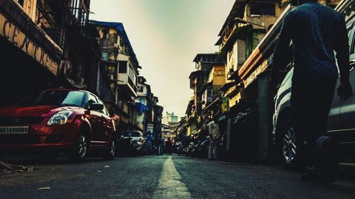 Vehicles on road along buildings