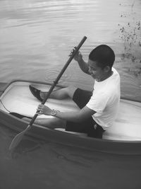 Man rowing boat in lake