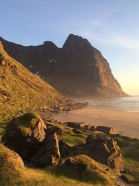 Rocky mountains by sea during sunset