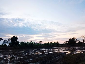 Scenic view of land against sky during sunset