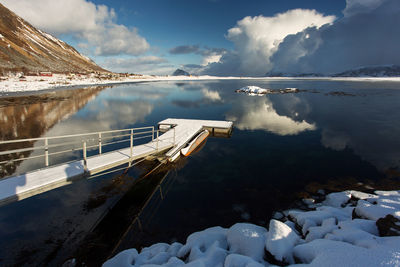 View of pier in lake against sky