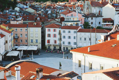 Red roofs of old town piran with main church against the sunrise sky, adriatic sea. slovenia