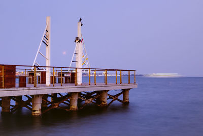 Pier over sea against clear sky