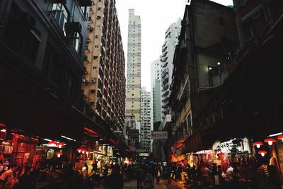 People on market street amidst buildings
