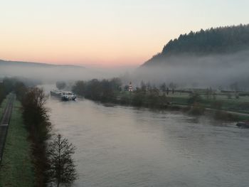 Scenic view of river against sky during sunset