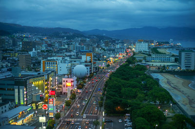 High angle view of illuminated cityscape against sky at dusk