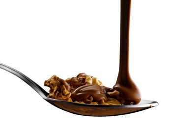Close-up of cake on plate against white background