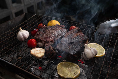 High angle view of meat on barbecue grill