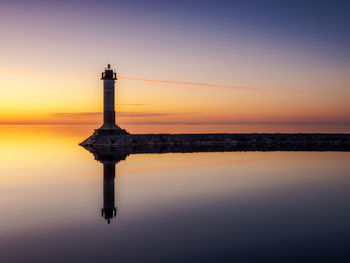 Beacon on the shore of lake ladoga in the evening twilight