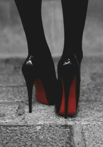 low section, shoe, person, red, footwear, close-up, indoors, standing, black color, fashion, pair, one person, part of, focus on foreground, black, selective focus, flooring, human foot, high heels