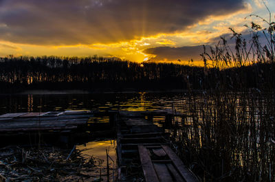 Scenic view of lake against sky at sunset