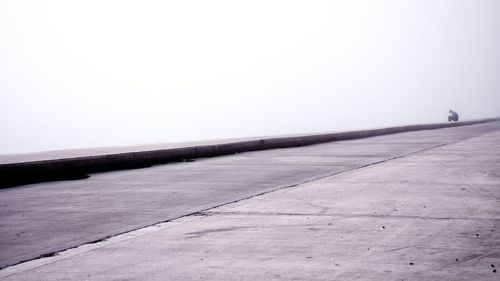 Surface level of footpath against sky