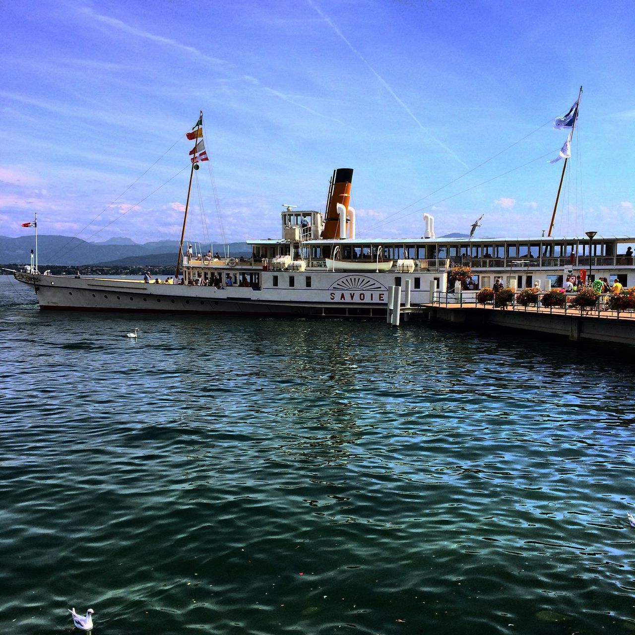 water, built structure, architecture, waterfront, building exterior, sky, transportation, blue, rippled, river, connection, bridge - man made structure, nautical vessel, incidental people, day, pier, sea, harbor, outdoors, mode of transport