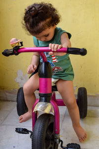 Cute little boy shivaay driving cycle at home balcony during summer time, sweet little boy