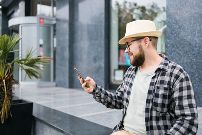 Side view of man using mobile phone