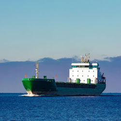 Ship sailing on sea against sky