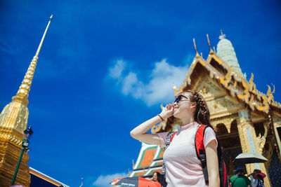 Low angle view of woman standing against temple