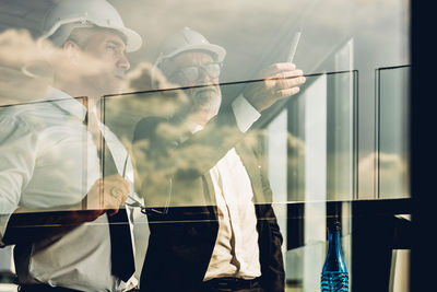 Reflection of man on glass window