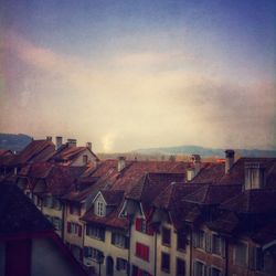 Buildings against cloudy sky