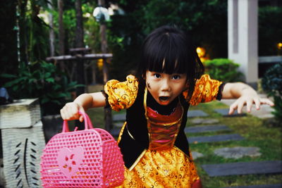 Portrait of shocked girl at yard