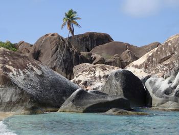 Scenic view of rocks in sea against clear sky