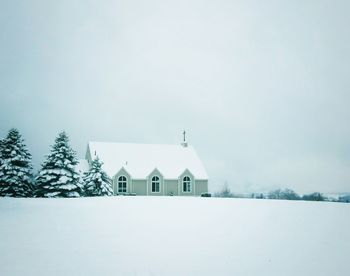 Built structure on snow covered land against sky