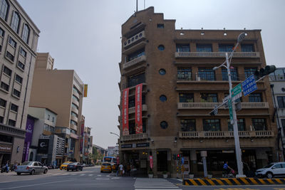 City street and buildings against sky