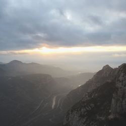 Scenic view of mountains against cloudy sky