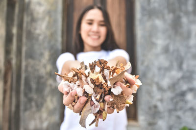 Side view of woman holding flower bouquet