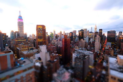 Skyscrapers in city during sunset