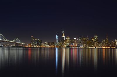 Illuminated city at waterfront