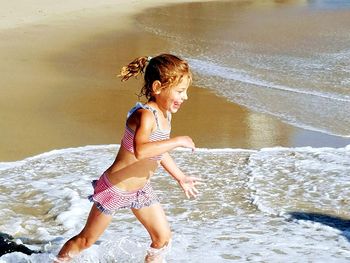 Full length of girl enjoying at beach