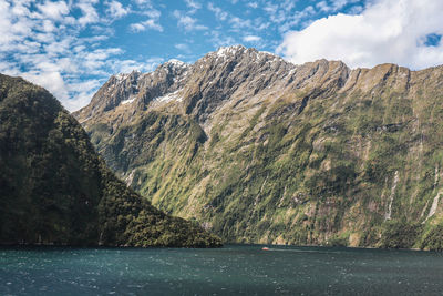 Scenic view of sea and mountains against sky