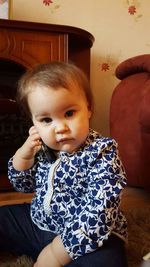 Portrait of cute girl sitting at home