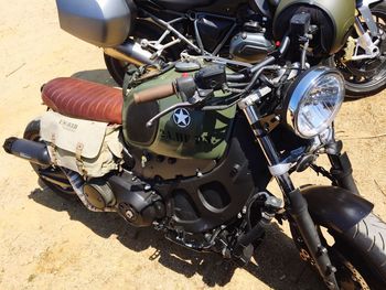 Close-up of motorcycle on sand