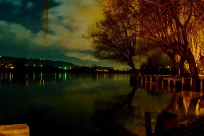 Scenic view of river against sky at night
