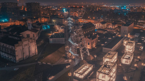 High angle view of illuminated buildings in city at night