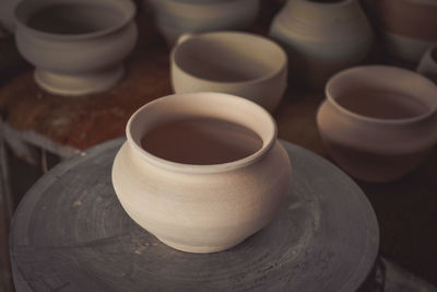 Clay pot on a potter's wheel close-up. copy spase