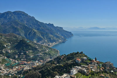 High angle view of townscape by sea against sky