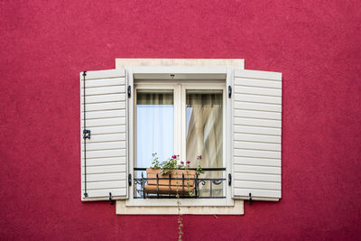 Closed window of red house