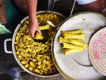 Cropped image of man removing food from container