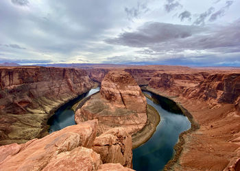 Scenic view of rock formations against cloudy sky