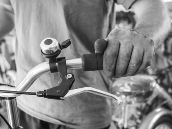 Midsection of man repairing bicycle