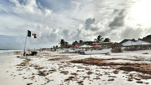 View of beach against cloudy sky