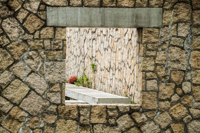 Close-up of stone wall by building