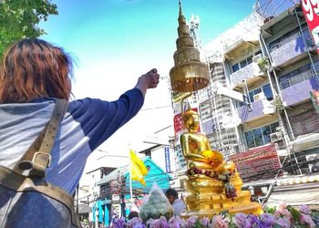 Rear view of woman with buildings in background