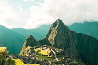 Panoramic view of building and mountains against sky