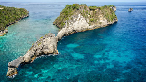 High angle view of rocks on sea shore